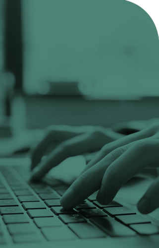 Hands typing on computer keyboard