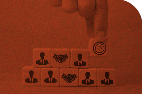 Finger holding bullseye block away from blocks with business man and hand shakes