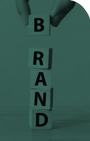 Blocks spelling out Brand with hand holding B Block