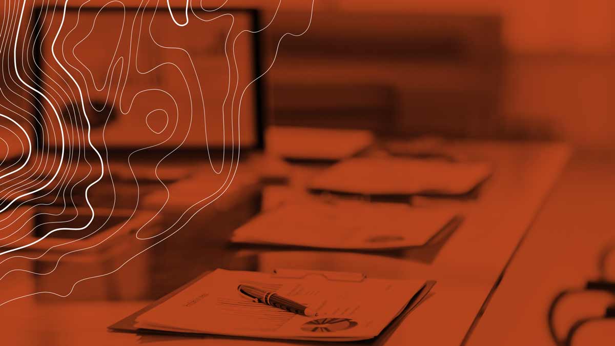 Laptop on desk with MDF paperwork