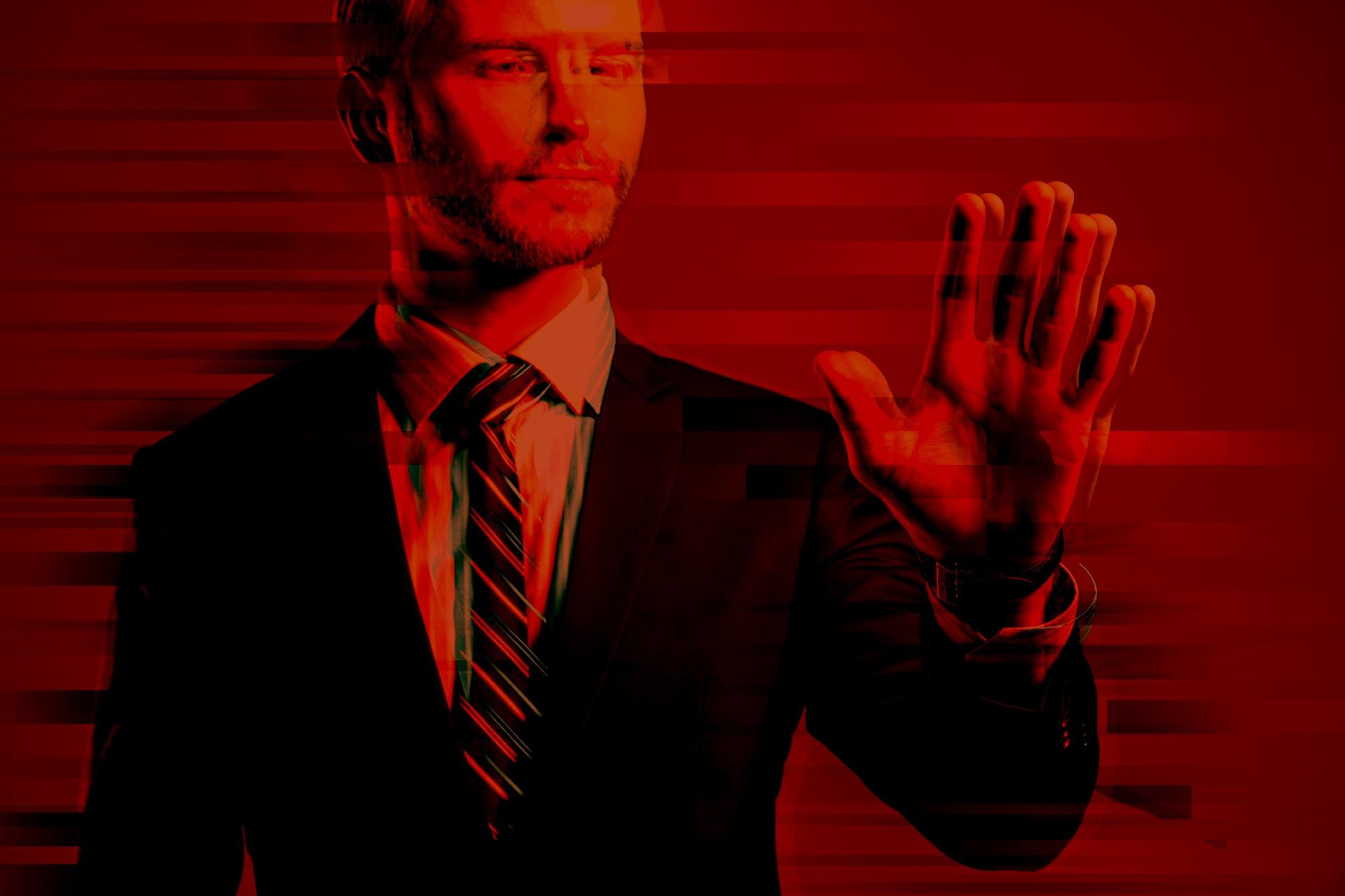 Businessman in a suit reaching out with his hand, overlaid with digital glitch effects and a red-toned futuristic design.