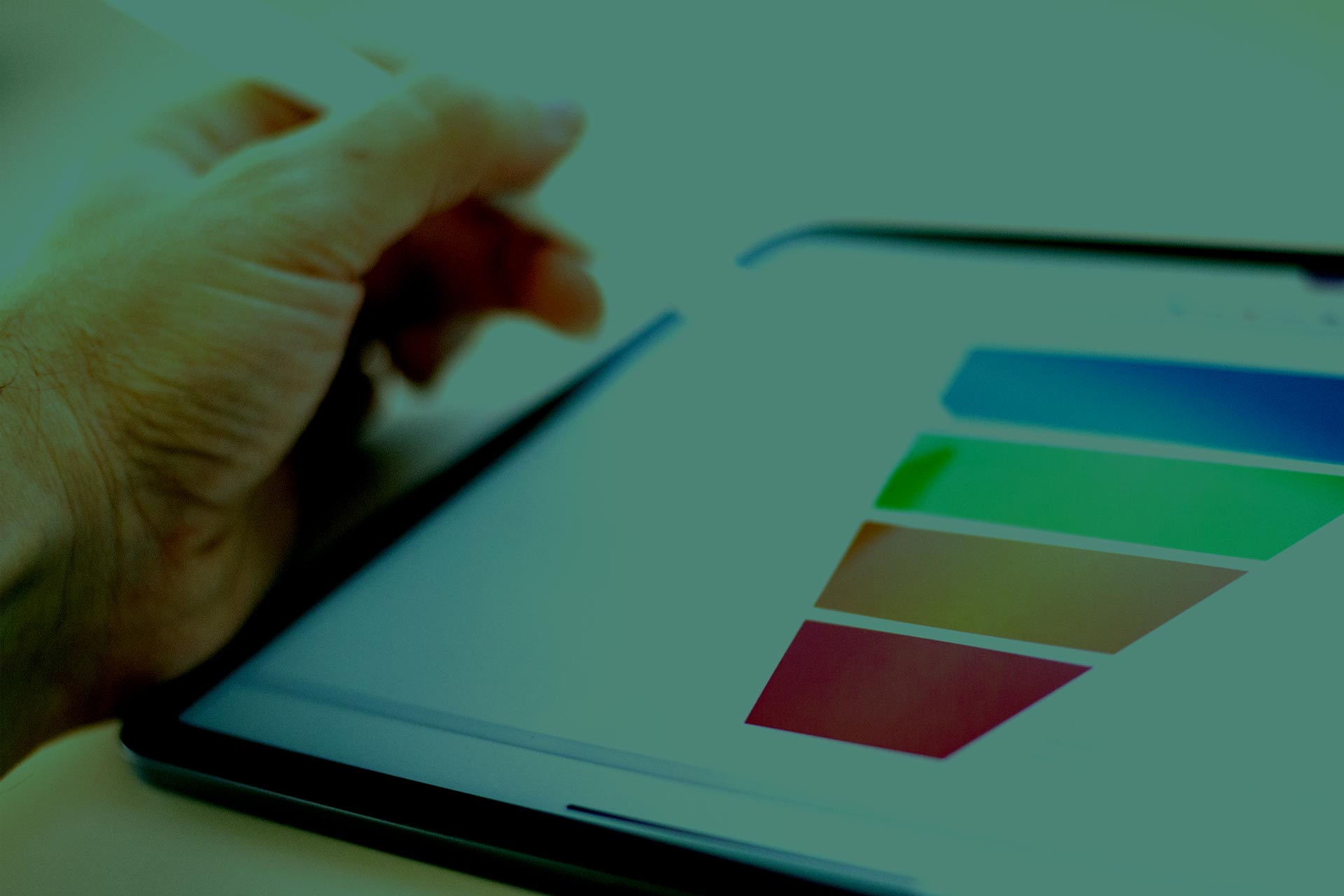 Close-up of a hand using a stylus on a tablet displaying a colorful funnel chart, representing data analysis or digital marketing.