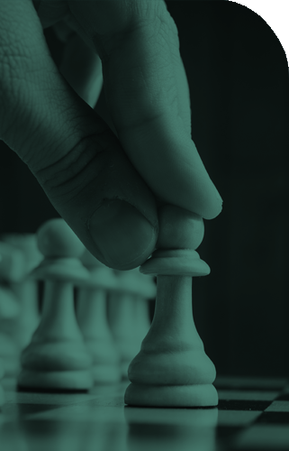 Hand moving a chess piece to represent strategic planning and business decision-making.